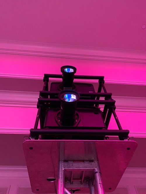 Christie Projectors double stacked rear projection in a pink room.